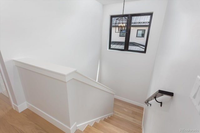 126 Chase St, Salida, CO 81201 - staircase with wood finished floors, baseboards, and a chandelier