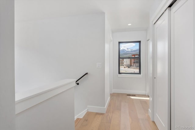126 Chase St, Salida, CO 81201 - corridor with light wood-style flooring, baseboards, recessed lighting, and an upstairs landing