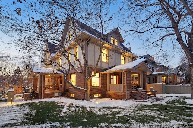 view of snow covered rear of property