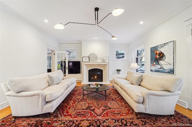 living room with hardwood / wood-style floors and crown molding