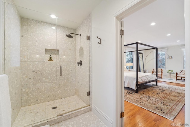 bathroom featuring hardwood / wood-style floors and walk in shower