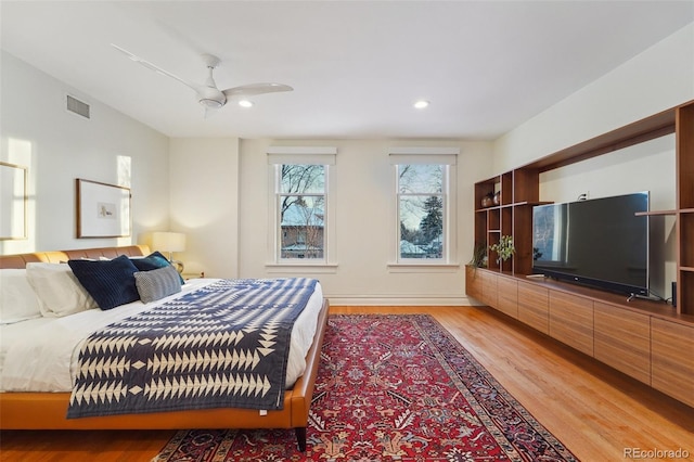 bedroom with ceiling fan and light hardwood / wood-style flooring