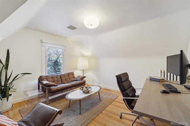 office area featuring hardwood / wood-style floors and lofted ceiling