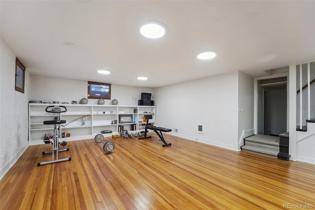 workout area with hardwood / wood-style flooring