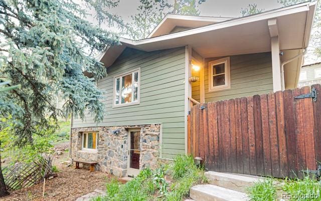 2795 SE Grapevine Rd, Idledale, CO 80453 - view of side of property with fence and stone siding