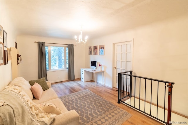 2795 SE Grapevine Rd, Idledale, CO 80453 - living area featuring a chandelier, light wood-type flooring, and baseboards