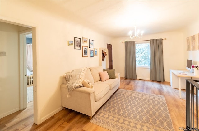2795 SE Grapevine Rd, Idledale, CO 80453 - living area featuring light wood-type flooring, a chandelier, and baseboards