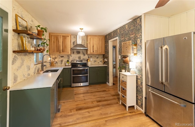 2795 SE Grapevine Rd, Idledale, CO 80453 - kitchen featuring appliances with stainless steel finishes, a sink, wall chimney range hood, open shelves, and light wood-style floors