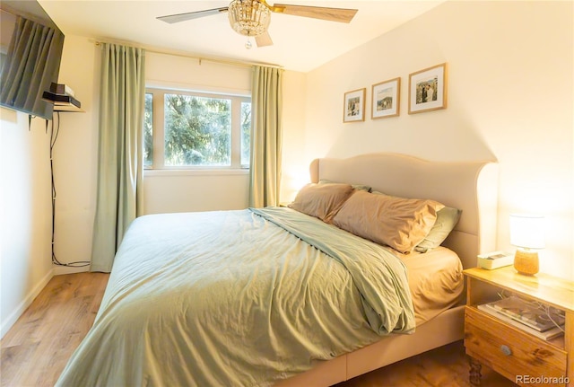 2795 SE Grapevine Rd, Idledale, CO 80453 - bedroom with wood finished floors, baseboards, and a ceiling fan
