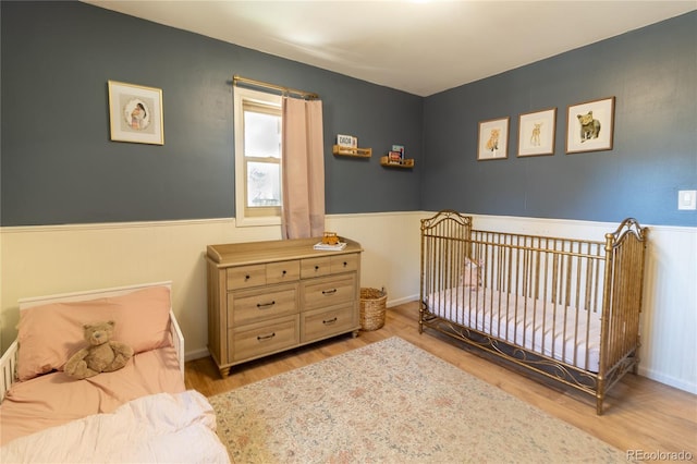 2795 SE Grapevine Rd, Idledale, CO 80453 - bedroom with wood finished floors and wainscoting