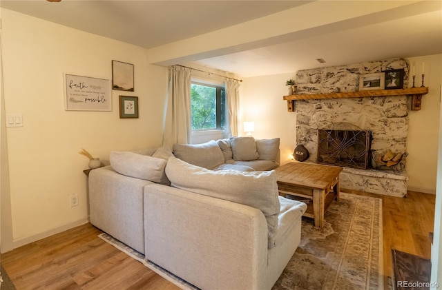 2795 SE Grapevine Rd, Idledale, CO 80453 - living area featuring a fireplace, wood finished floors, and baseboards