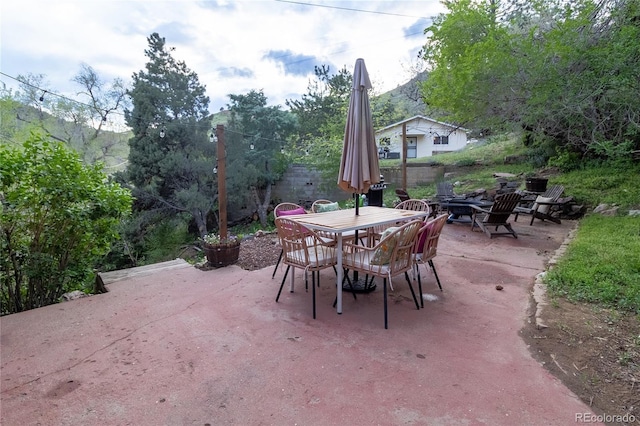 2795 SE Grapevine Rd, Idledale, CO 80453 - view of patio with outdoor dining area and an outdoor fire pit