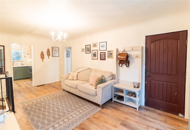 2795 SE Grapevine Rd, Idledale, CO 80453 - living area with a chandelier and light wood-style flooring