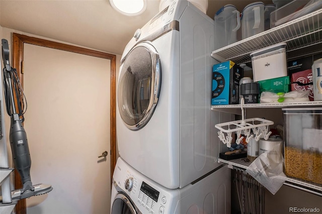 washroom featuring stacked washer / drying machine