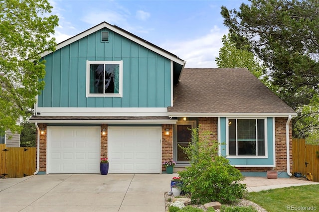 8140 S Storm King Peak, Littleton, CO 80127 - view of front of house with board and batten siding, a garage, fence, brick siding, and driveway