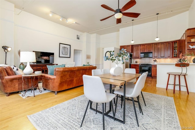 1140 Columbine St Unit 302, Denver, CO 80206 - dining area featuring a high ceiling, a ceiling fan, light wood-style floors, and track lighting