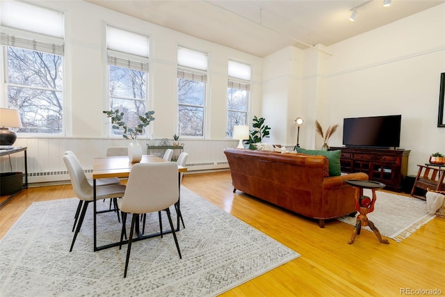 1140 Columbine St Unit 302, Denver, CO 80206 - dining room with a baseboard radiator and wood finished floors