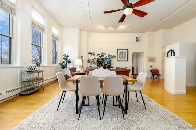 1140 Columbine St Unit 302, Denver, CO 80206 - dining area featuring light wood finished floors, a ceiling fan, track lighting, and a towering ceiling