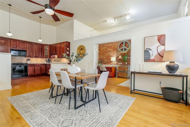 1140 Columbine St Unit 302, Denver, CO 80206 - dining room with ceiling fan, light wood-style flooring, rail lighting, and a high ceiling