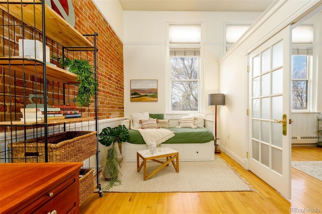 1140 Columbine St Unit 302, Denver, CO 80206 - living area featuring hardwood / wood-style floors, brick wall, and baseboard heating