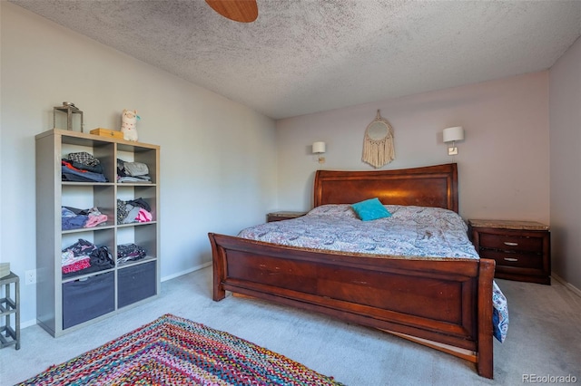 bedroom featuring a textured ceiling, baseboards, and carpet floors