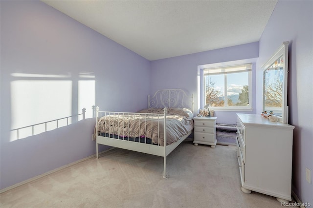 bedroom with vaulted ceiling and light colored carpet