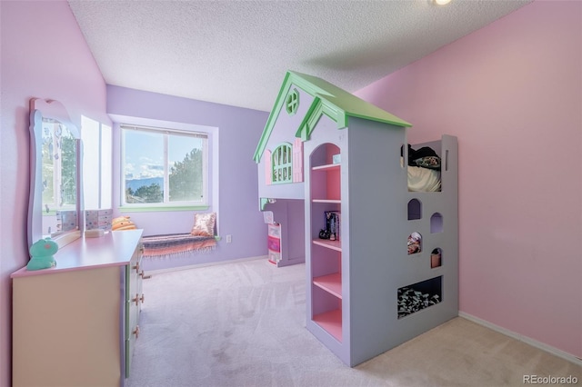 playroom with light colored carpet and a textured ceiling