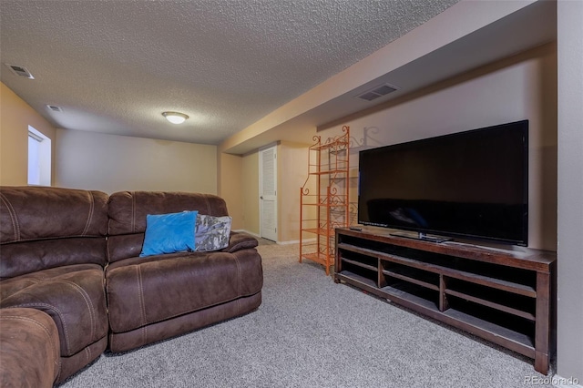 carpeted living room with visible vents and a textured ceiling