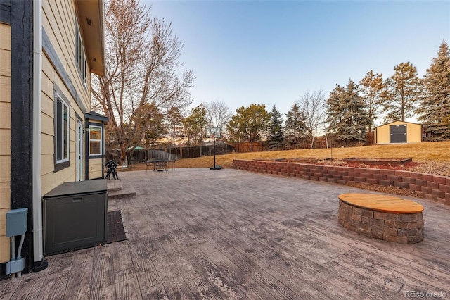 view of patio with a storage unit, an outdoor structure, and a fenced backyard