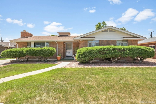 4705 Upham St, Wheat Ridge, CO 80033 - ranch-style home with brick siding, a front lawn, and a chimney
