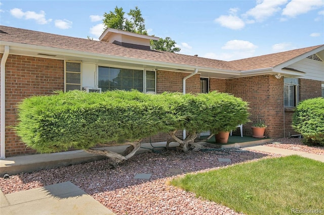 4705 Upham St, Wheat Ridge, CO 80033 - property entrance featuring brick siding and roof with shingles