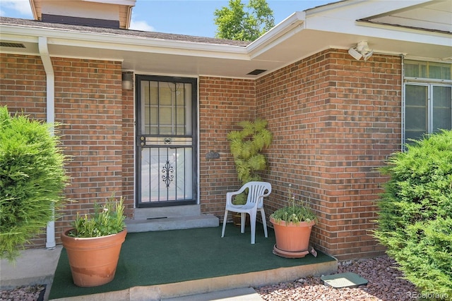 4705 Upham St, Wheat Ridge, CO 80033 - doorway to property featuring brick siding and a porch