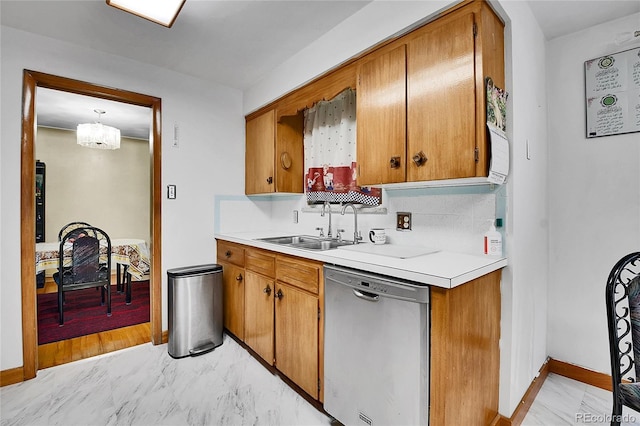 4705 Upham St, Wheat Ridge, CO 80033 - kitchen featuring stainless steel dishwasher, light countertops, brown cabinetry, and light marble finish floors