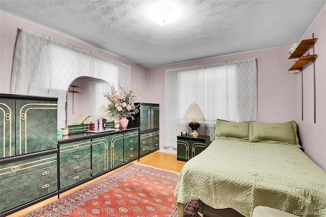 4705 Upham St, Wheat Ridge, CO 80033 - bedroom with arched walkways and light wood finished floors