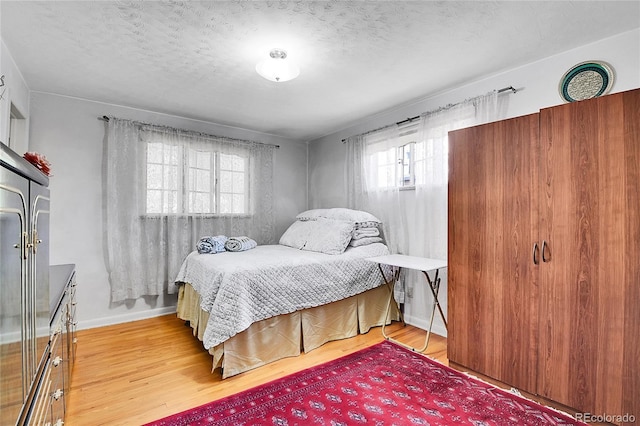 4705 Upham St, Wheat Ridge, CO 80033 - bedroom with wood finished floors and a textured ceiling