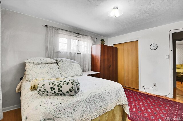 4705 Upham St, Wheat Ridge, CO 80033 - bedroom featuring wood finished floors and a closet