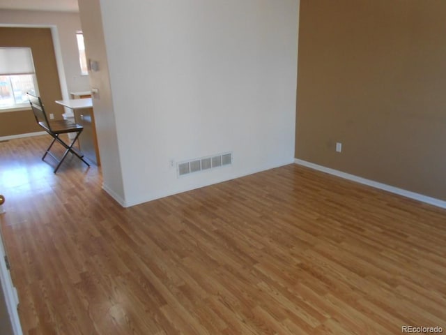 spare room with hardwood / wood-style floors