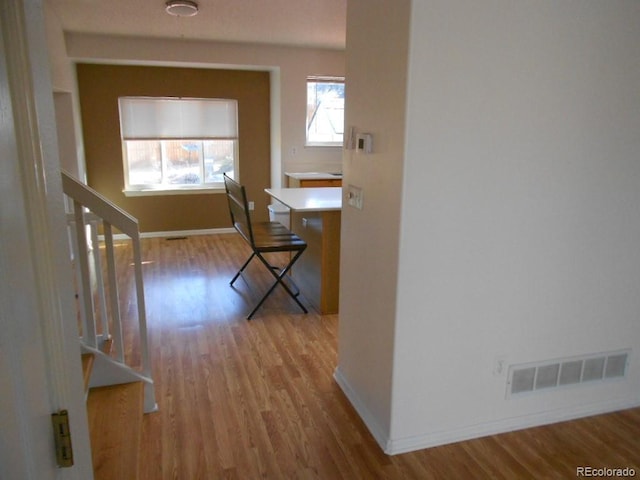 corridor with light hardwood / wood-style floors