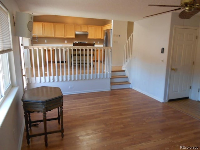 kitchen featuring dark wood-type flooring, stainless steel fridge, and ceiling fan