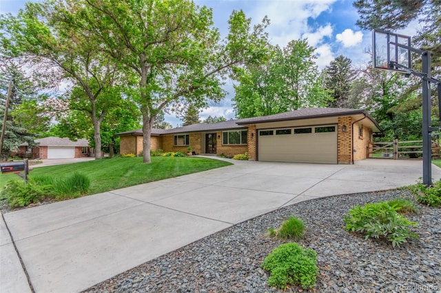 5890 W Quarles Dr, Littleton, CO 80128 - ranch-style house with an attached garage, brick siding, and concrete driveway