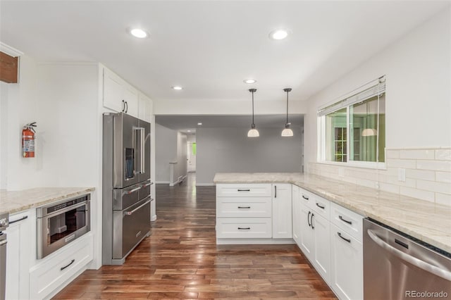 5890 W Quarles Dr, Littleton, CO 80128 - kitchen with appliances with stainless steel finishes, a peninsula, dark wood finished floors, white cabinetry, and recessed lighting