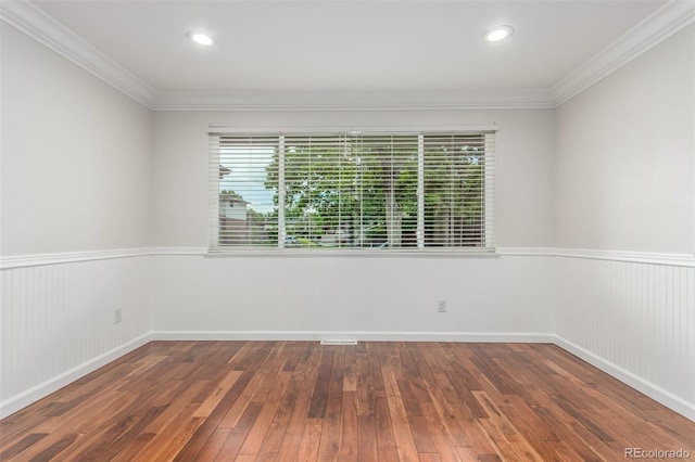 5890 W Quarles Dr, Littleton, CO 80128 - spare room featuring a wainscoted wall, wood-type flooring, and crown molding