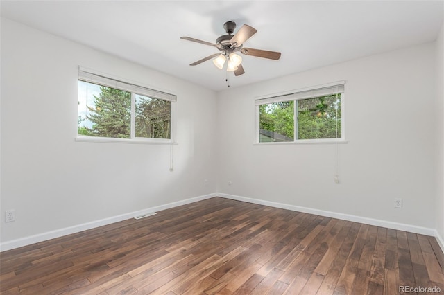 5890 W Quarles Dr, Littleton, CO 80128 - spare room featuring plenty of natural light, dark wood-type flooring, baseboards, and a ceiling fan