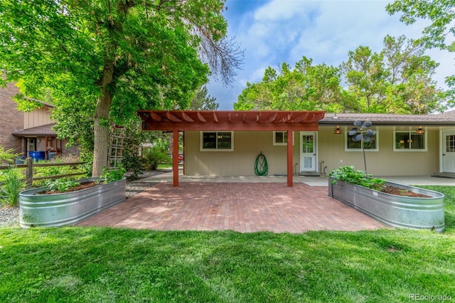 5890 W Quarles Dr, Littleton, CO 80128 - back of property featuring a patio, a lawn, and a vegetable garden