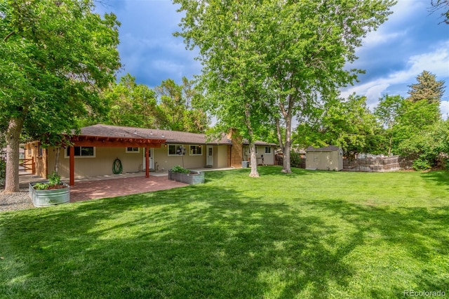 5890 W Quarles Dr, Littleton, CO 80128 - back of house with a patio area and a lawn