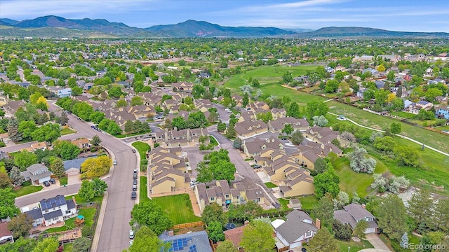 10389 W Fair Ave Unit E, Littleton, CO 80127 - aerial overview of property's location with a mountainous background and nearby suburban area