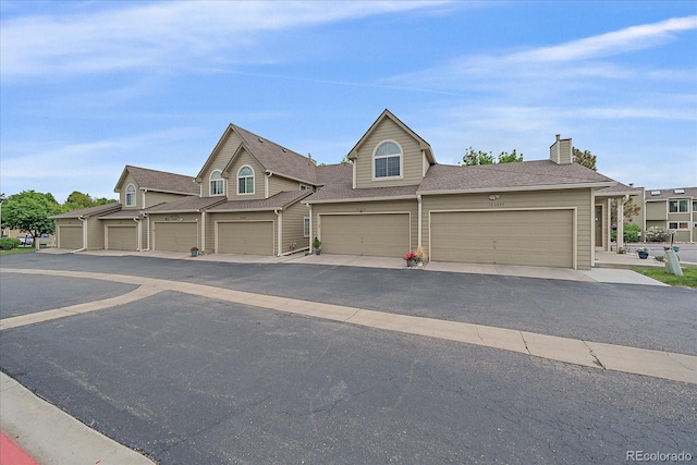 10389 W Fair Ave Unit E, Littleton, CO 80127 - view of property featuring a chimney