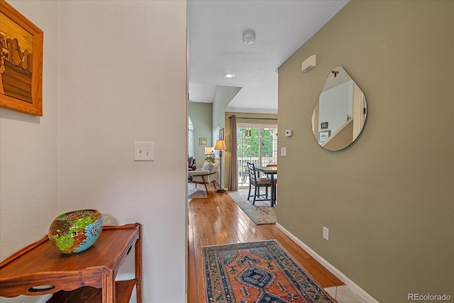 10389 W Fair Ave Unit E, Littleton, CO 80127 - hallway featuring wood finished floors and baseboards