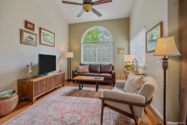 10389 W Fair Ave Unit E, Littleton, CO 80127 - living room with ceiling fan, wood finished floors, baseboards, and lofted ceiling