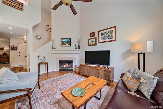 10389 W Fair Ave Unit E, Littleton, CO 80127 - living area featuring ceiling fan, baseboards, a fireplace, wood finished floors, and recessed lighting